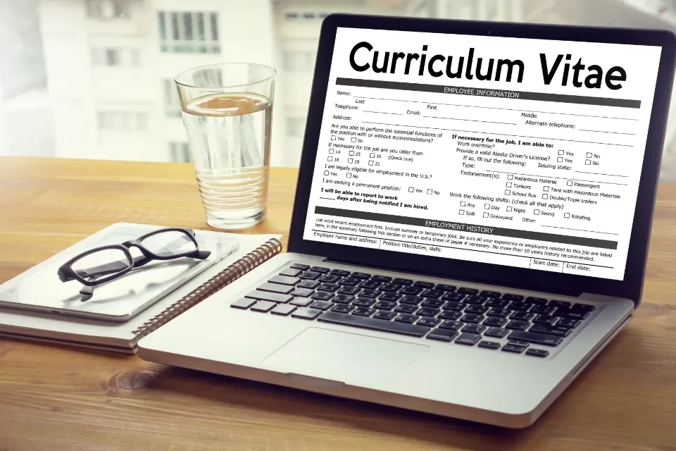 laptop with screen showing image of curriculum vitae